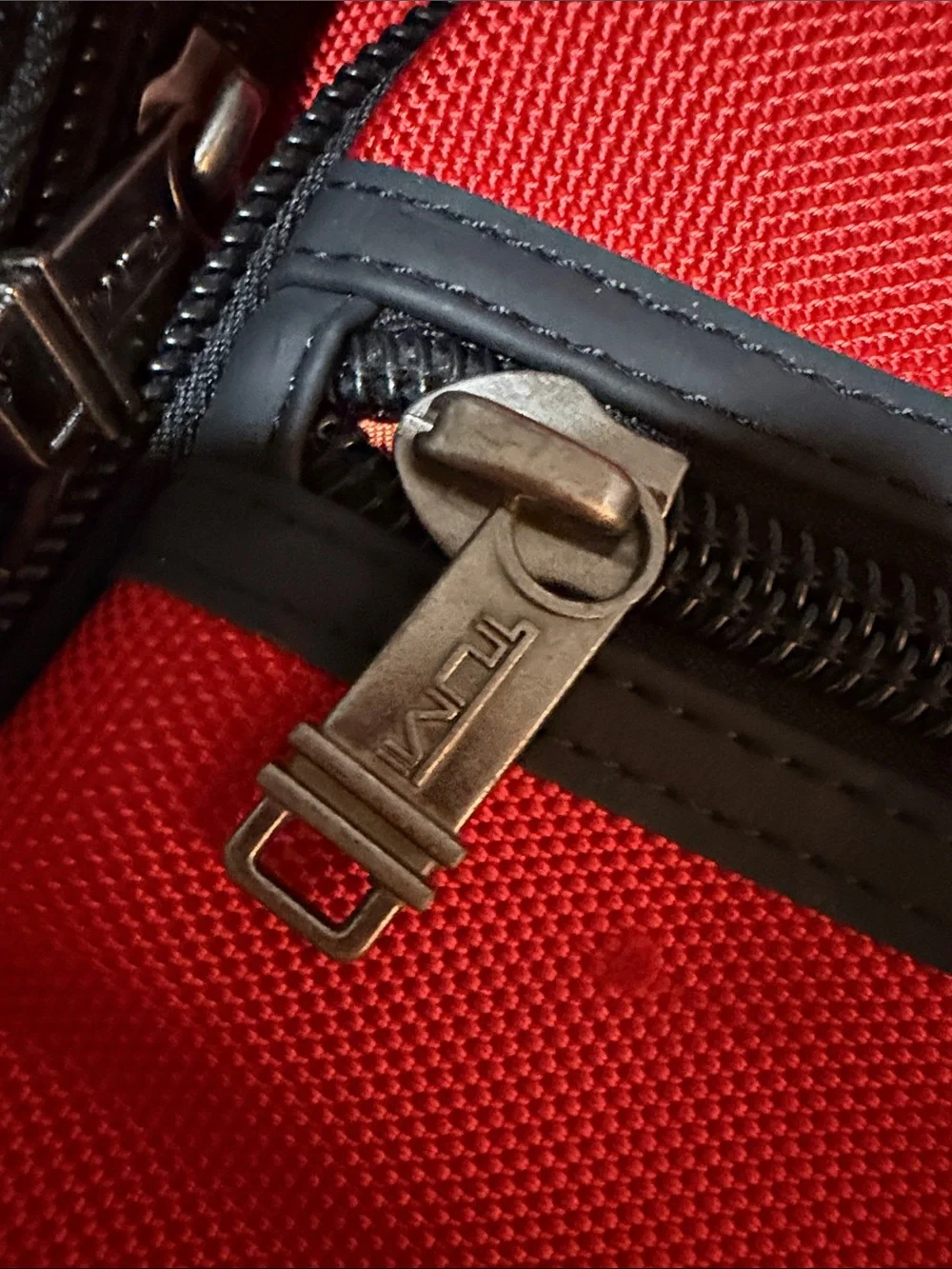 Tumi Red and Black Men/Women’s Backpack with Multiple Front Pockets